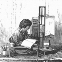 Person studying a book at a desk