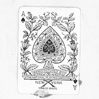 Black and white image of an ace of spades card, manufactured by the national playing card company.